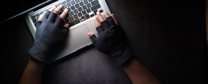 person in black long sleeve shirt using macbook pro